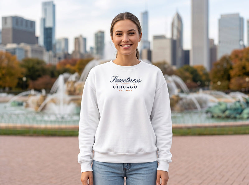 Woman wearing a white Sweetness Script Chicago crewneck at Buckingham Fountain