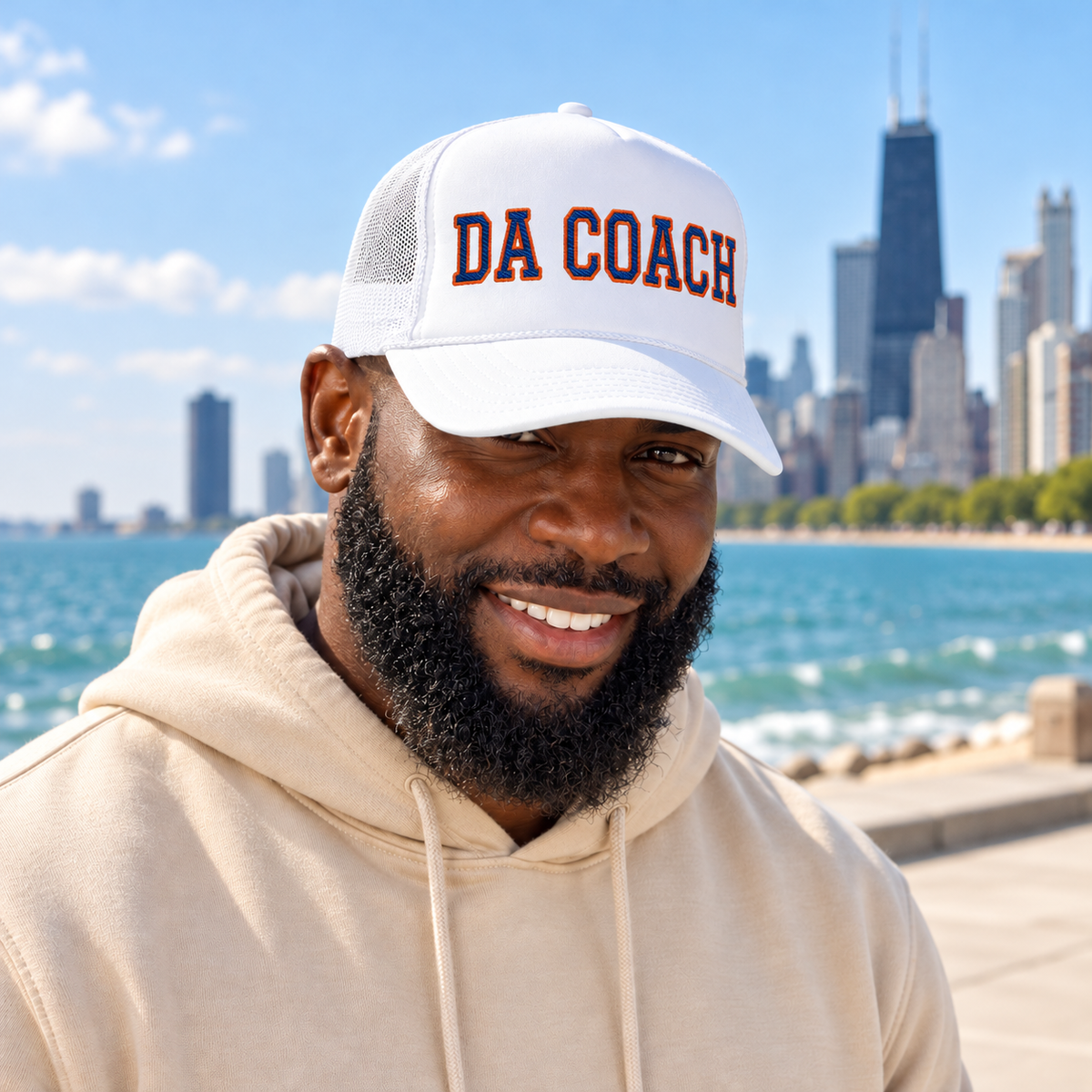 Man wearing the Da Coach embroidered foam trucker hat in all white on the Chicago lakefront