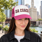 Woman wearing the Da Coach embroidered foam trucker hat in white and pink on the Chicago Riverwalk