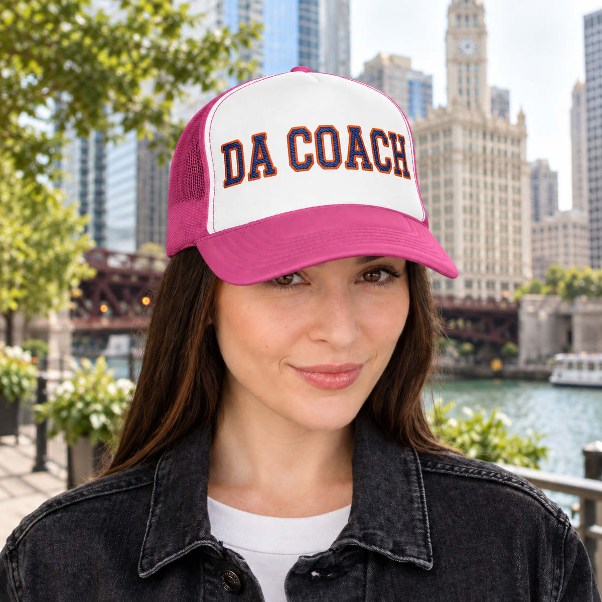 Woman wearing the Da Coach embroidered foam trucker hat in white and pink on the Chicago Riverwalk