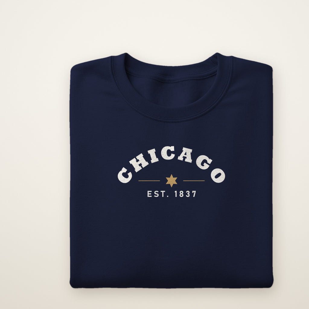 Chicago Est. 1837 youth crewneck in Navy, flat lay showing the arched CHICAGO and city star print