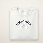 Chicago Est. 1837 youth crewneck in White, flat lay with navy arched CHICAGO and gold star