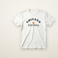 Chicago Football Jr. Varsity youth tee in White, flat lay with navy arched CHICAGO and football