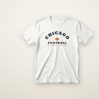 Chicago Football Jr. Varsity youth tee in White, flat lay with navy arched CHICAGO and football
