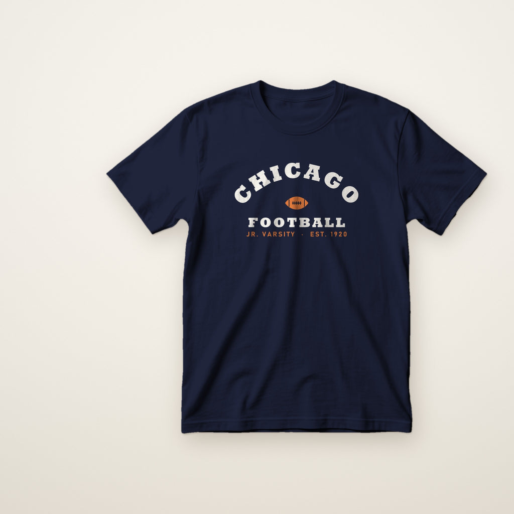 Chicago Football Jr. Varsity youth tee in Navy, flat lay with arched CHICAGO and football