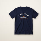 Chicago Football Jr. Varsity youth tee in Navy, flat lay with arched CHICAGO and football