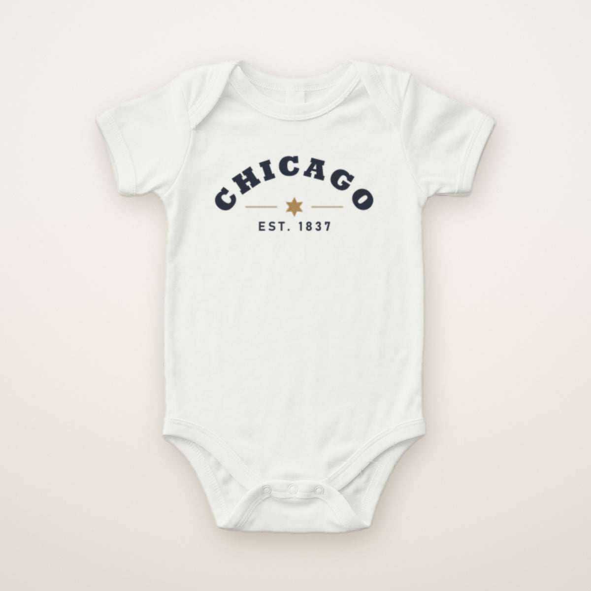 Chicago Est. 1837 baby bodysuit in White, flat lay with navy arched CHICAGO print