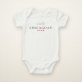 Little Chicagoan baby bodysuit in White, flat lay with gold script and four red stars