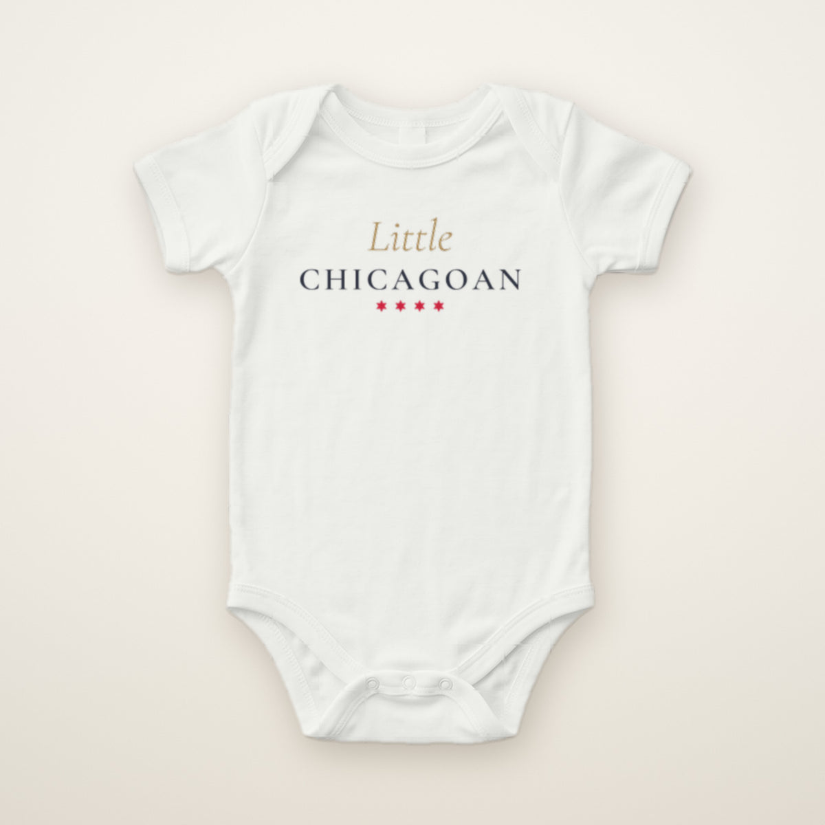 Little Chicagoan baby bodysuit in White, flat lay with gold script and four red stars