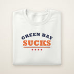 Green Bay Sucks Varsity crewneck in White, flat lay with navy and orange varsity lettering