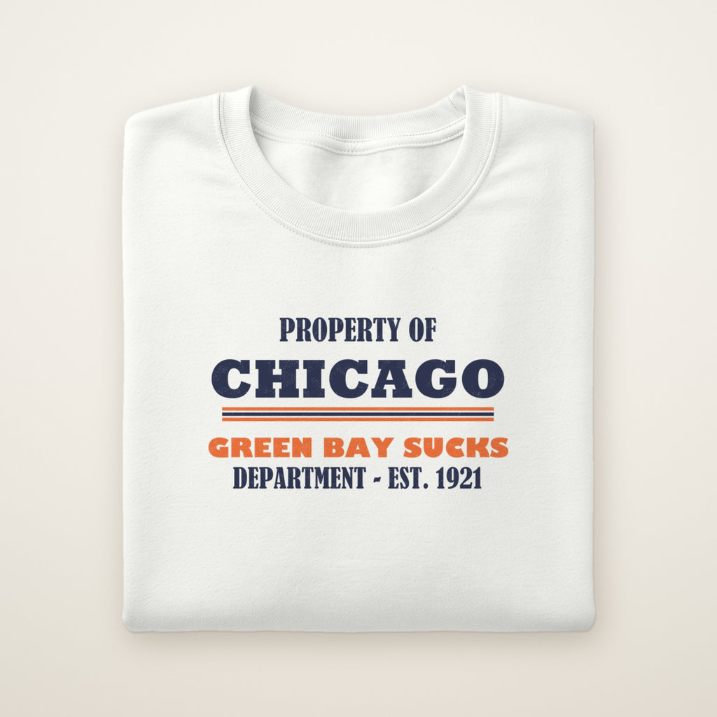 Property of Chicago Green Bay Sucks Dept. crewneck in White, flat lay with navy and orange print