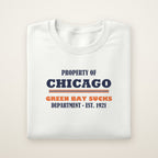 Property of Chicago Green Bay Sucks Dept. crewneck in White, flat lay with navy and orange print