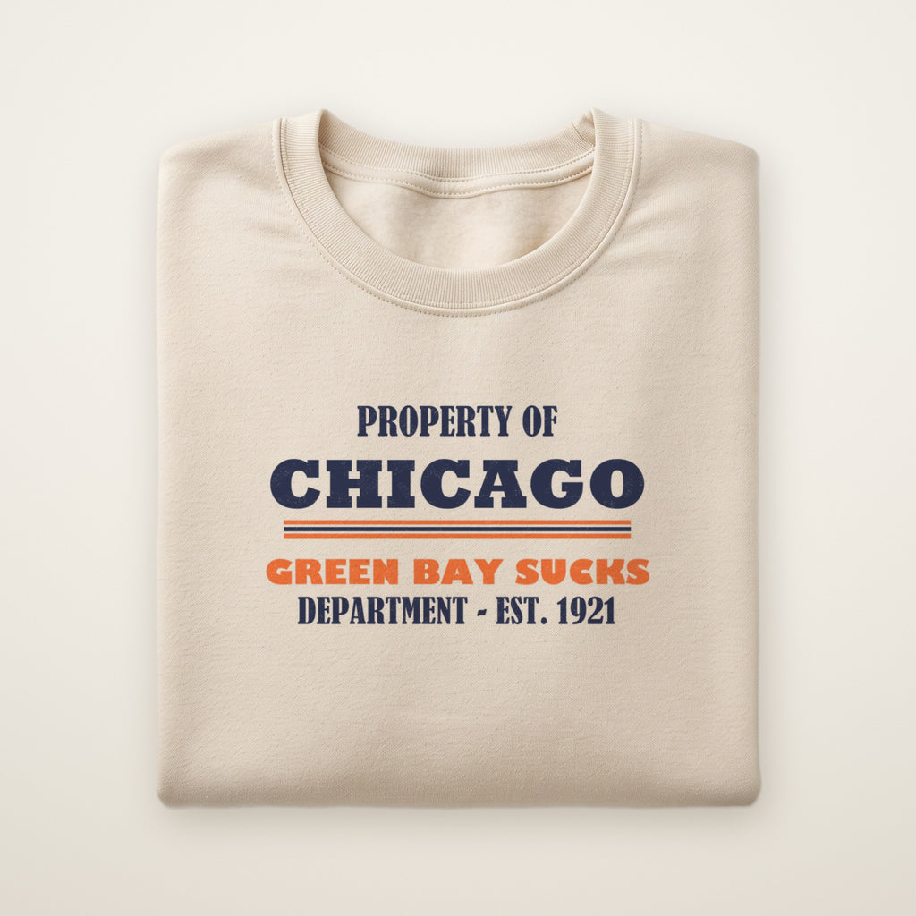 Property of Chicago Green Bay Sucks Dept. crewneck in Sand, flat lay with navy and orange print
