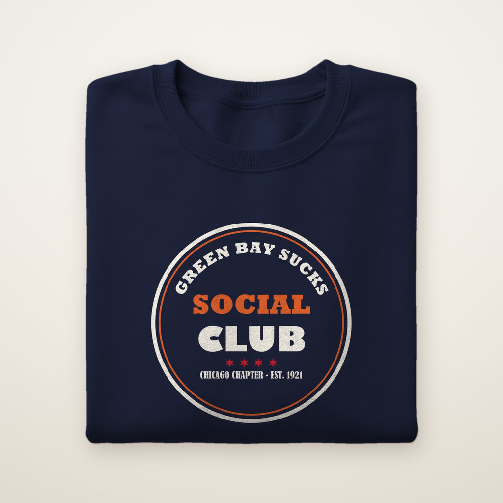 Green Bay Sucks Social Club crewneck in Navy, flat lay with circular Chicago Chapter badge