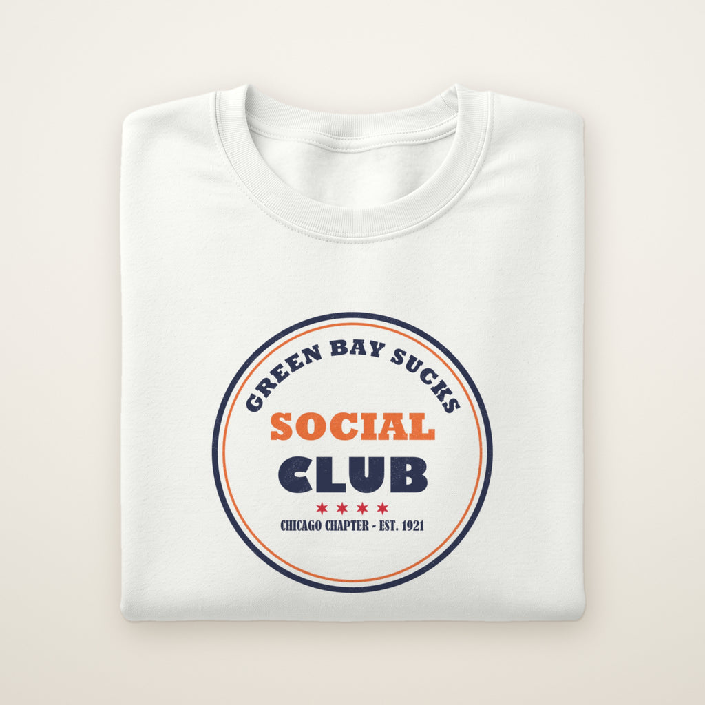 Green Bay Sucks Social Club crewneck in White, flat lay with navy and orange circle badge