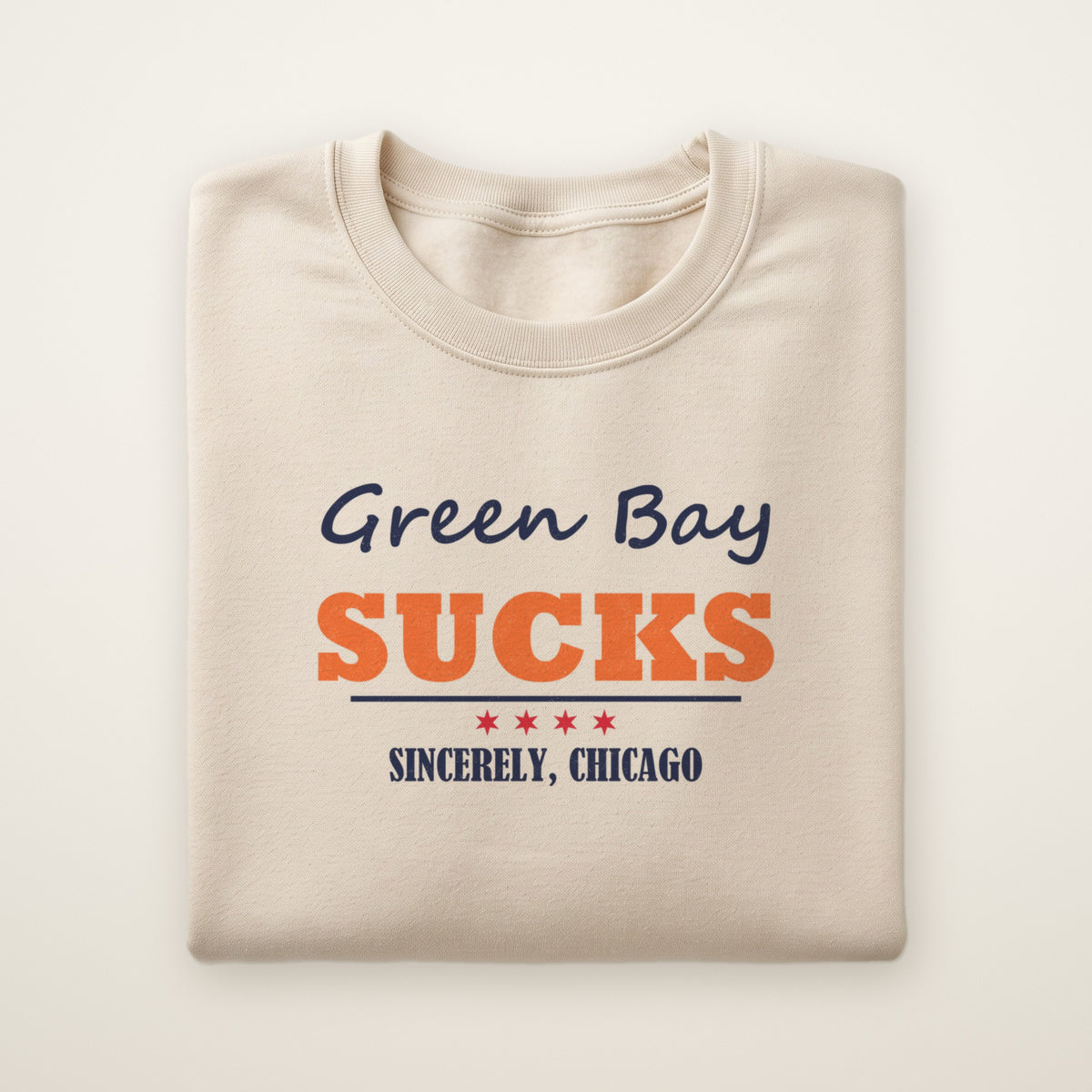 Green Bay Sucks Sincerely, Chicago crewneck in Sand, flat lay with script and orange SUCKS