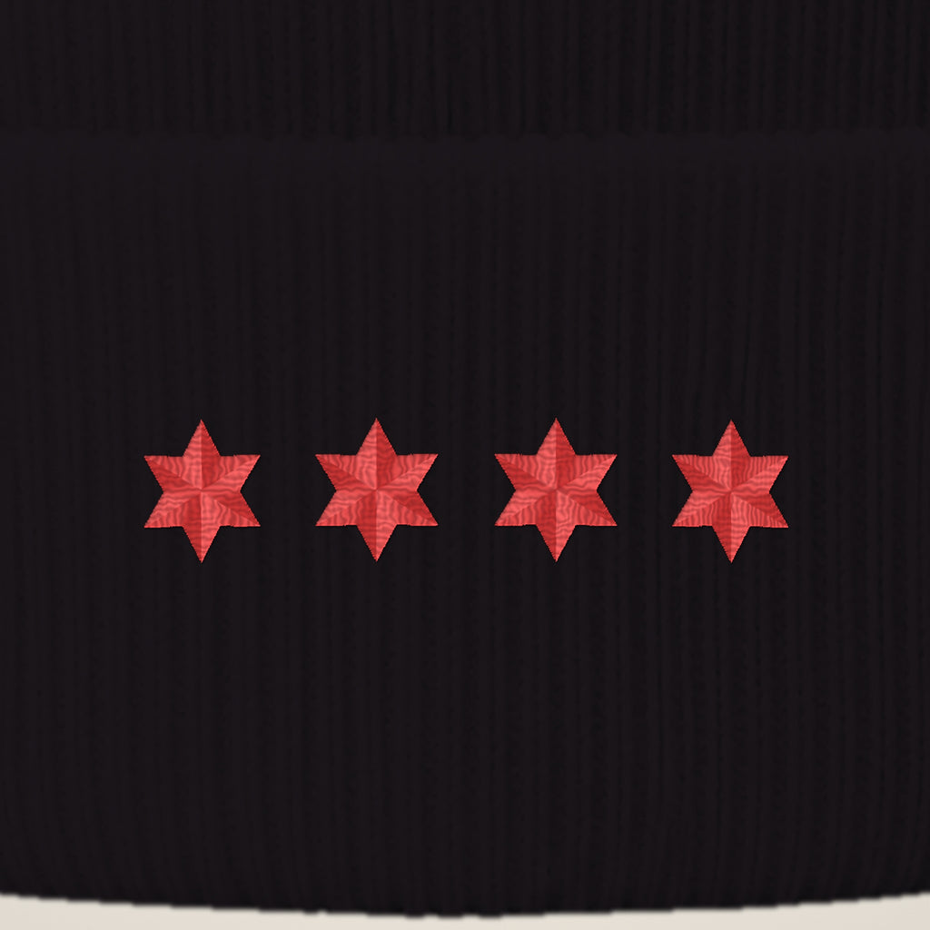 Close-up of four red embroidered six-point stars on the beanie cuff