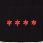 Close-up of four red embroidered six-point stars on the beanie cuff