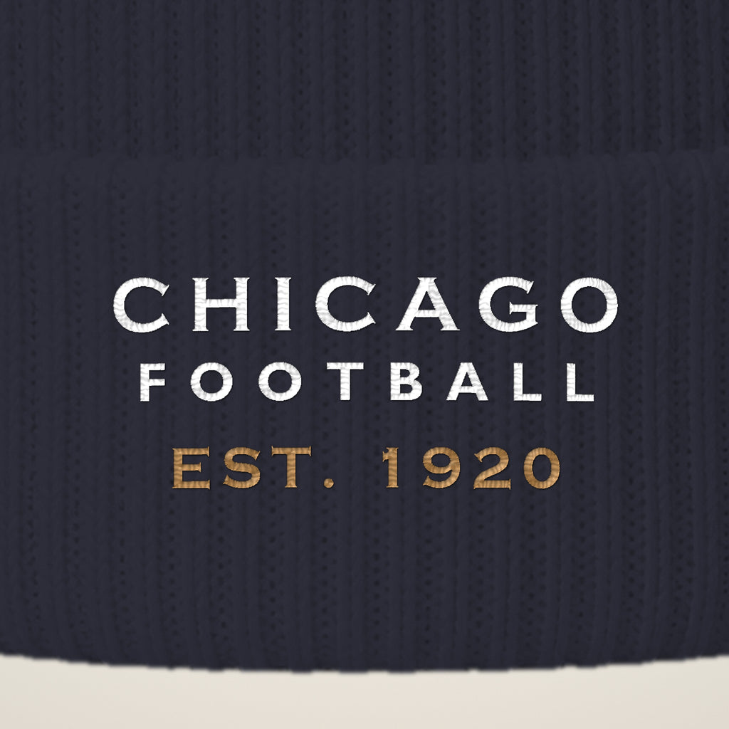 Close-up of CHICAGO FOOTBALL EST. 1920 embroidery on the pom-pom beanie cuff
