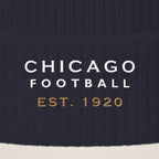 Close-up of CHICAGO FOOTBALL EST. 1920 embroidery on the pom-pom beanie cuff