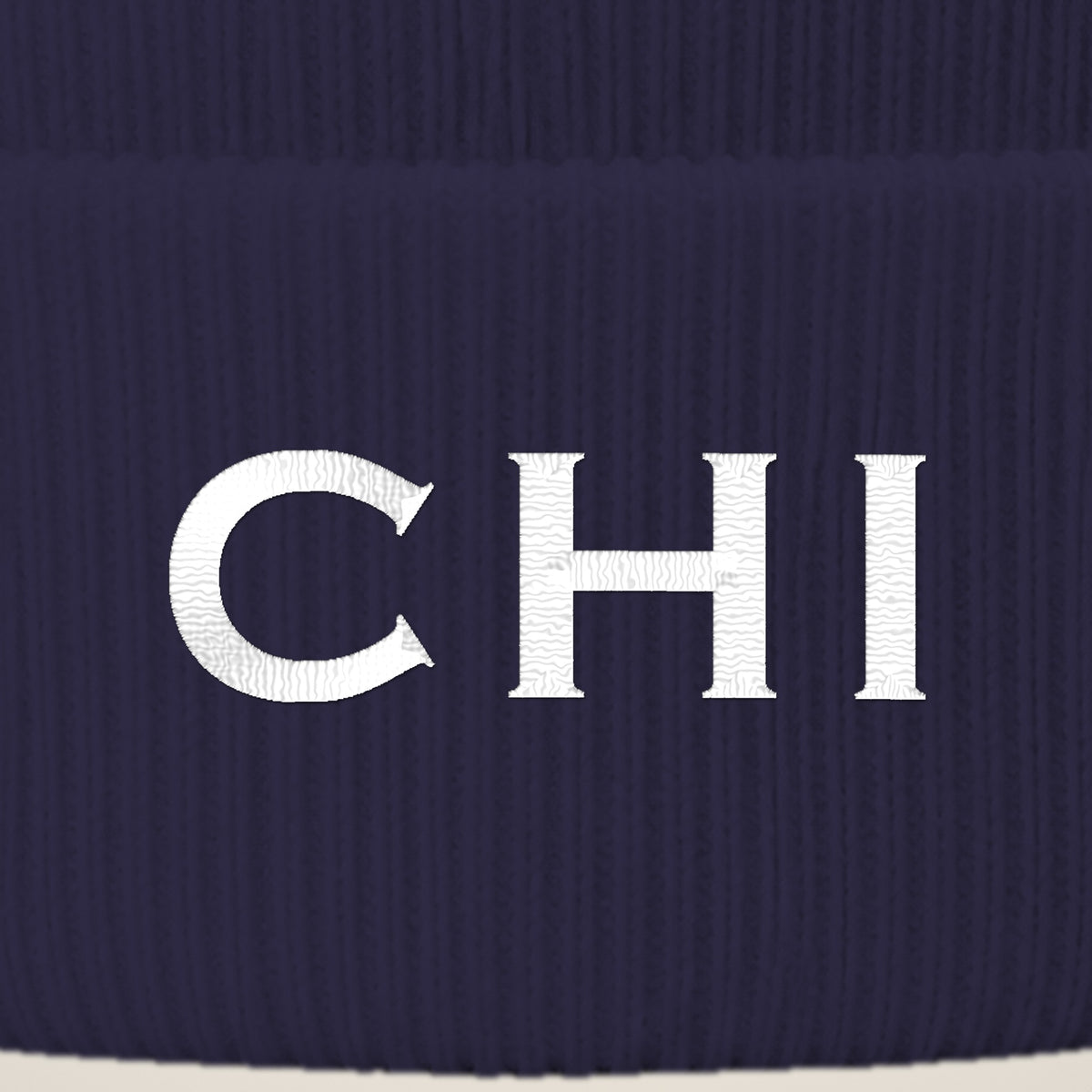 Close-up of CHI embroidery on the beanie cuff