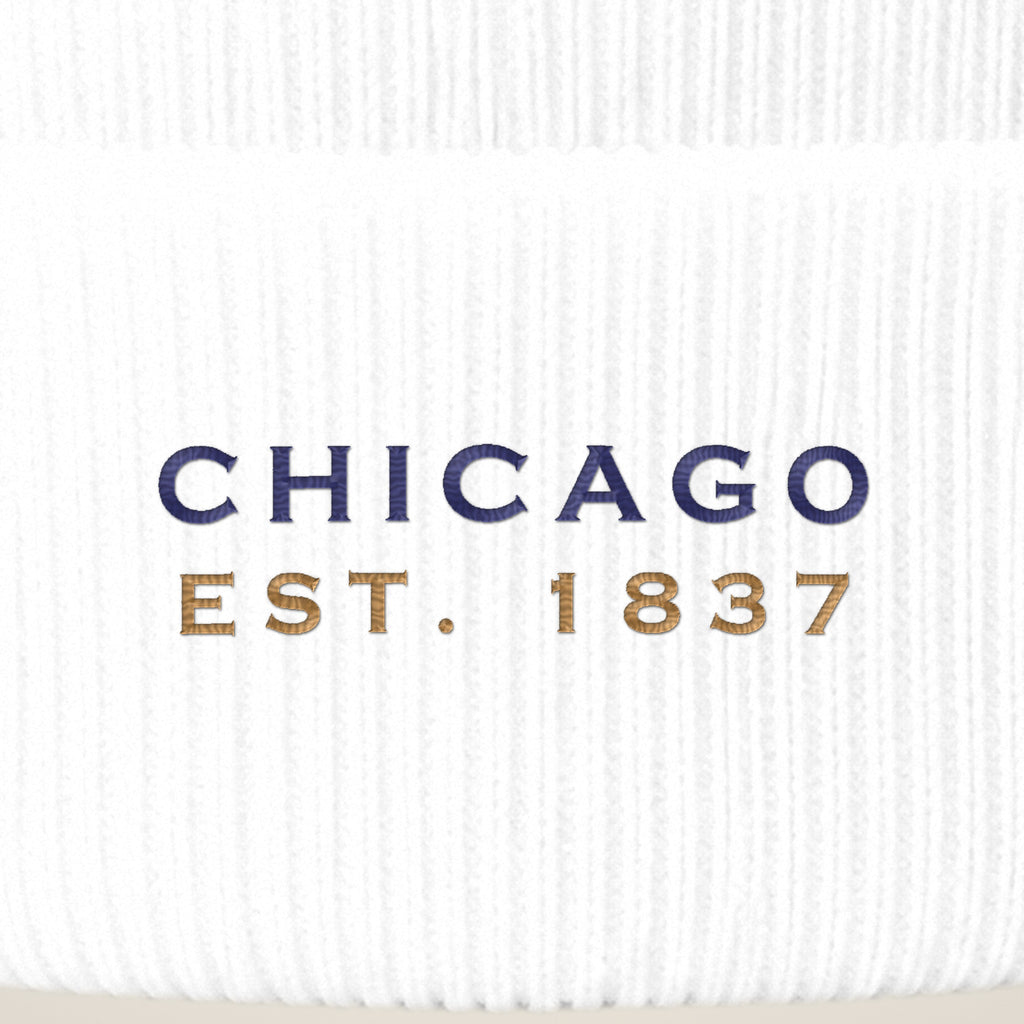Close-up of navy CHICAGO EST. 1837 embroidery on a white beanie cuff