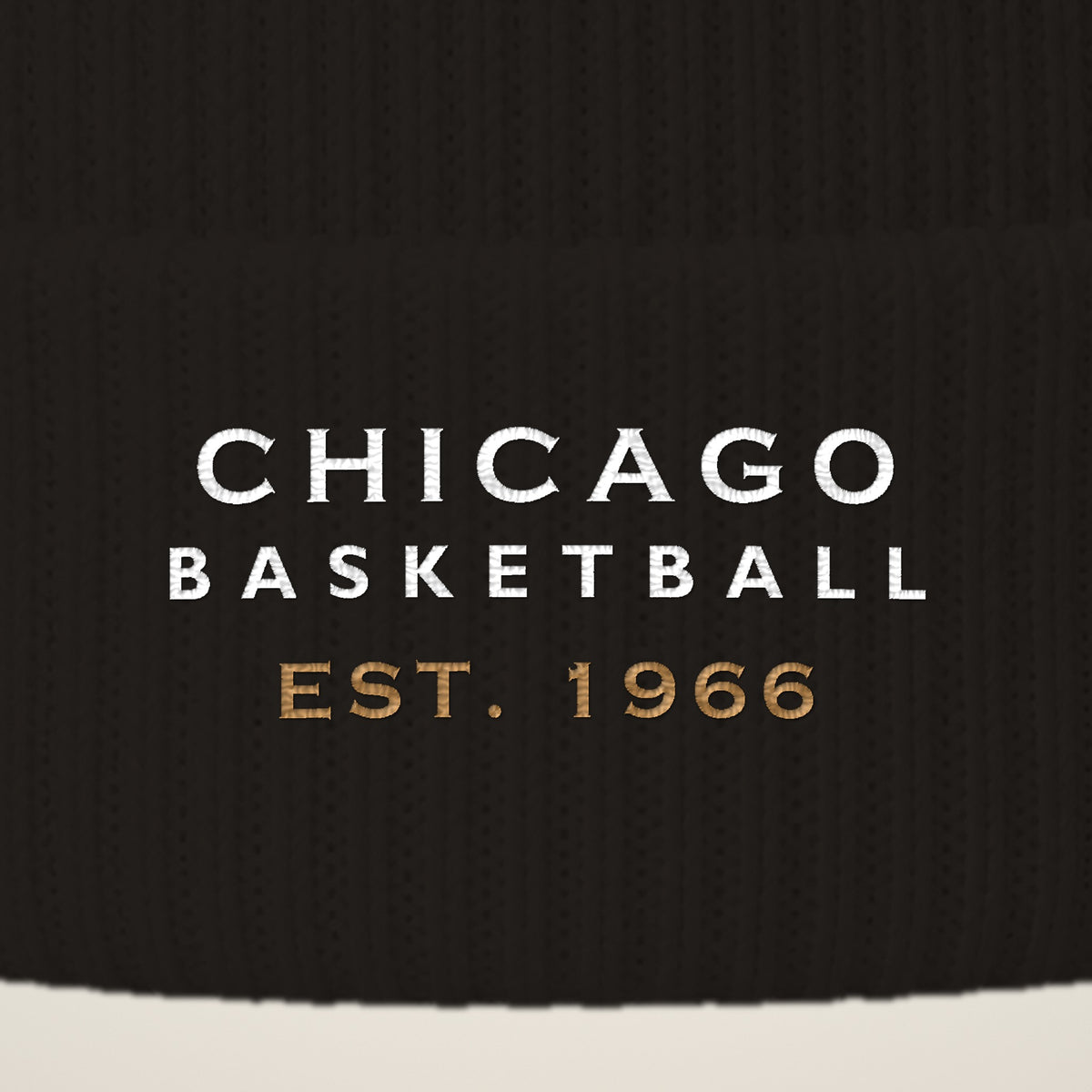 Close-up of CHICAGO BASKETBALL EST. 1966 embroidery on the pom-pom beanie cuff