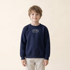 Child wearing the Chicago embroidered youth crewneck in Navy, white thread