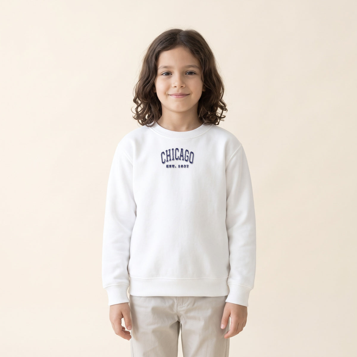 Child wearing the Chicago embroidered youth crewneck in White, navy thread