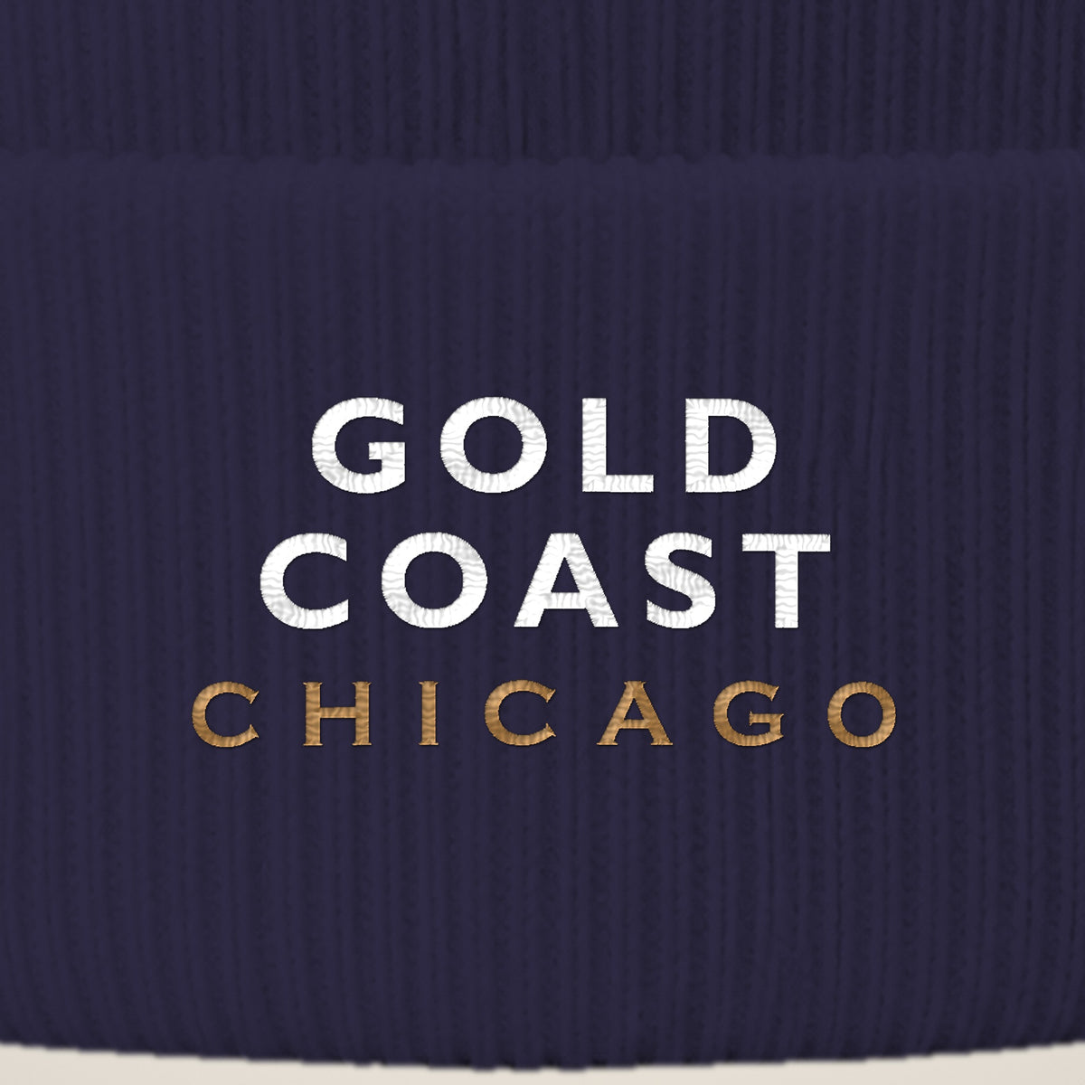 Gold Coast Chicago embroidery close-up in white and old gold thread