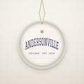 Andersonville Chicago Christmas Ornament, Est. 1854 hanging on a gold cord, ivory backdrop