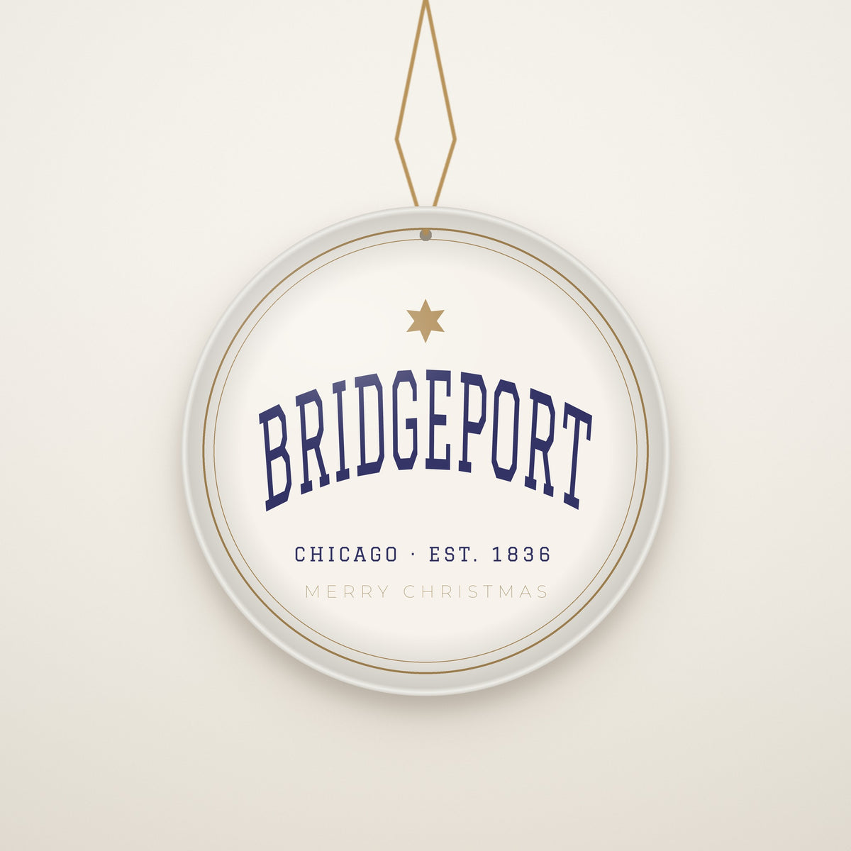 Bridgeport Chicago Christmas Ornament, Est. 1836 hanging on a gold cord, ivory backdrop