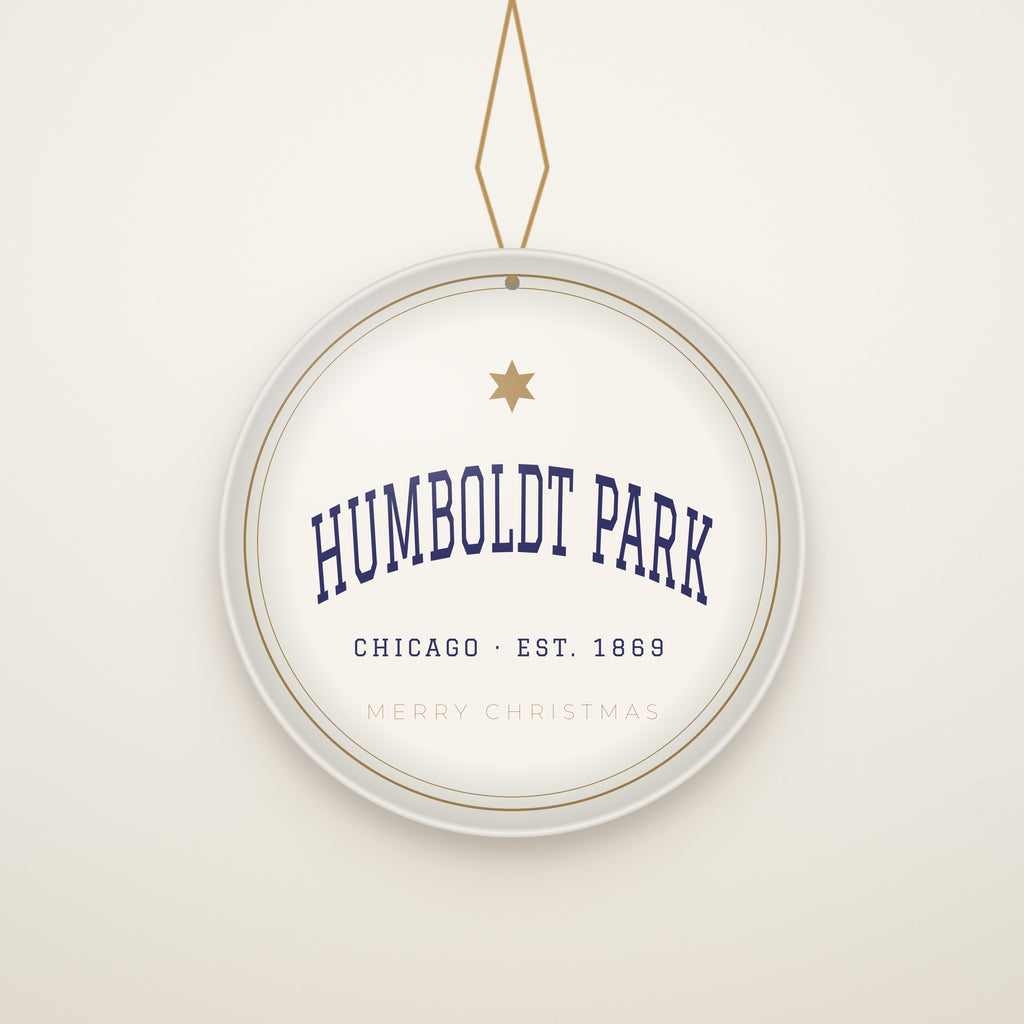 Humboldt Park Chicago Christmas Ornament, Est. 1869 hanging on a gold cord, ivory backdrop