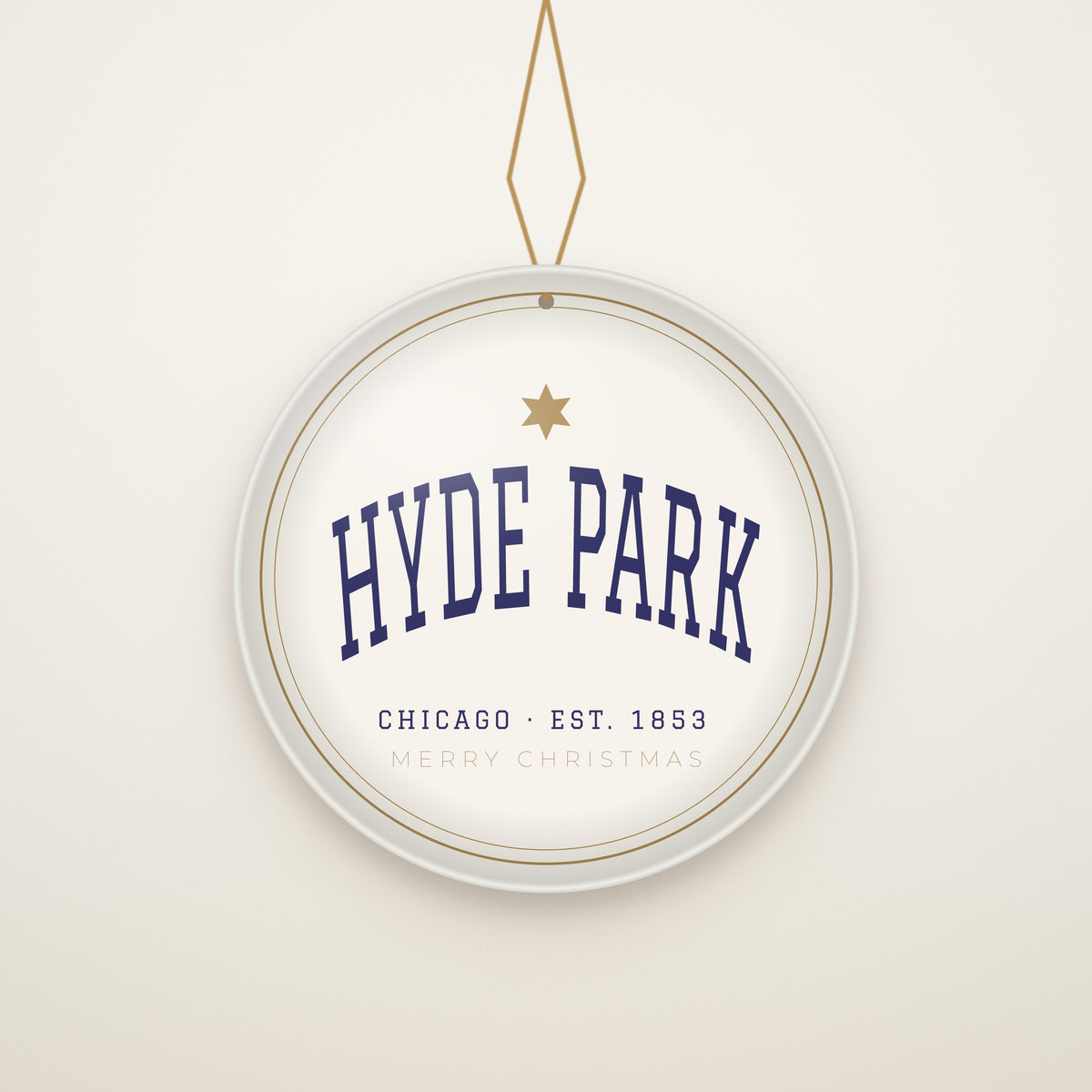 Hyde Park Chicago Christmas Ornament, Est. 1853 hanging on a gold cord, ivory backdrop