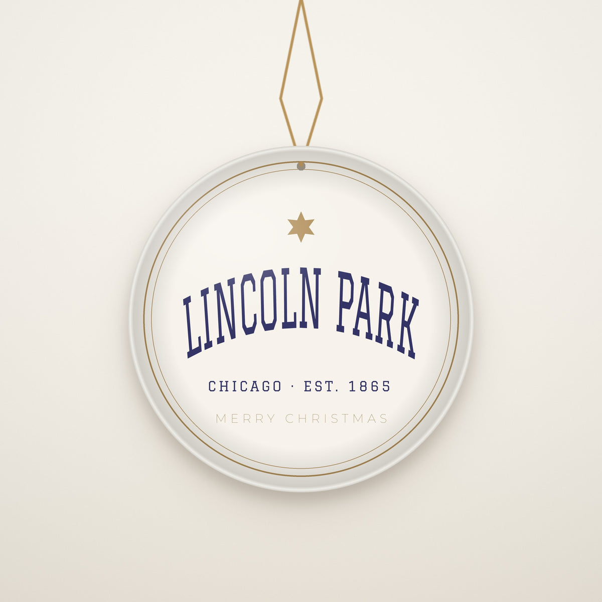 Lincoln Park Chicago Christmas Ornament, Est. 1865 hanging on a gold cord, ivory backdrop