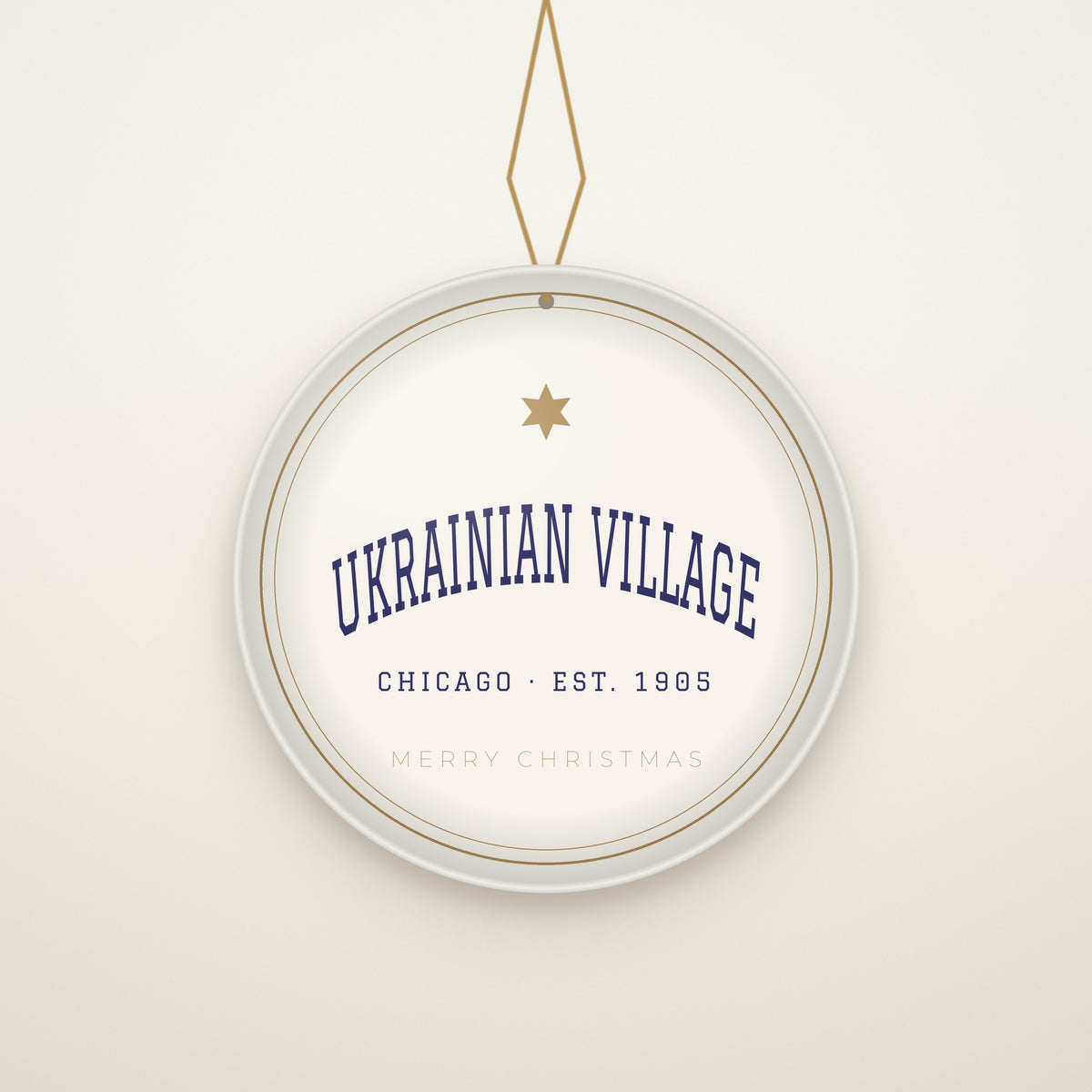 Ukrainian Village Chicago Christmas Ornament, Est. 1905 hanging on a gold cord, ivory backdrop