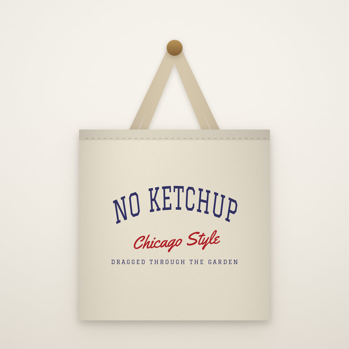 No Ketchup Canvas Tote Bag hanging from a brass peg on an ivory wall
