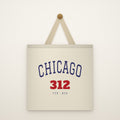 Chicago 312 Canvas Tote Bag hanging from a brass peg on an ivory wall