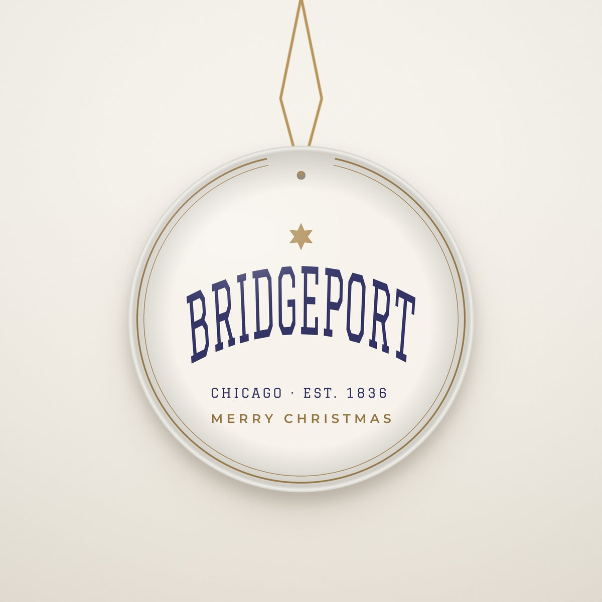 Bridgeport Chicago Christmas Ornament, Est. 1836 hanging on a gold cord, ivory backdrop