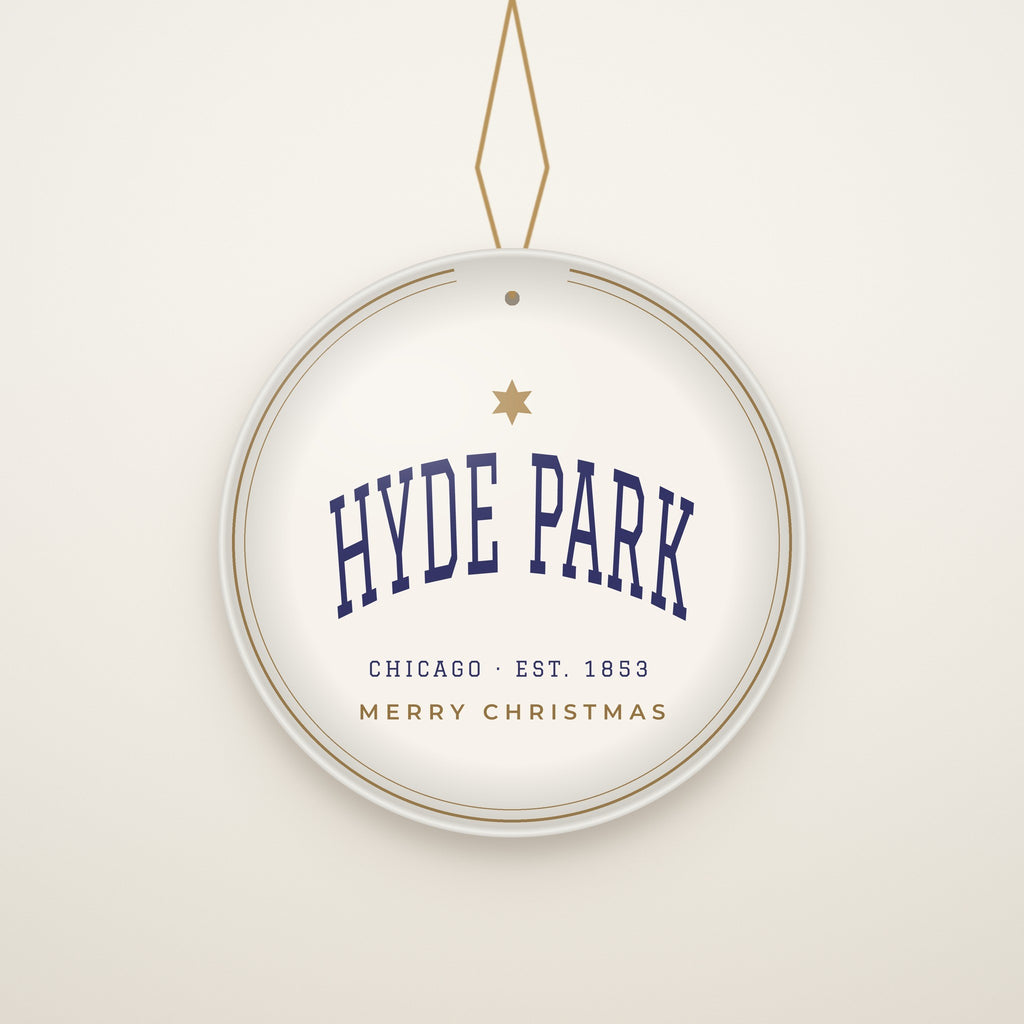 Hyde Park Chicago Christmas Ornament, Est. 1853 hanging on a gold cord, ivory backdrop