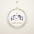 Hyde Park Chicago Christmas Ornament, Est. 1853 hanging on a gold cord, ivory backdrop