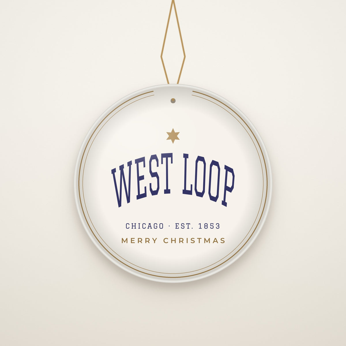 West Loop Chicago Christmas Ornament, Est. 1853 hanging on a gold cord, ivory backdrop