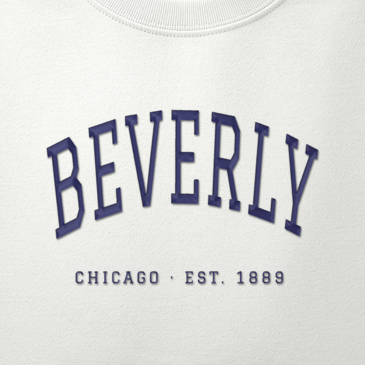 Close-up of navy satin-stitch Beverly embroidery