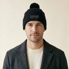 Model wearing the Chicago Basketball Est. 1966 Embroidered Pom-Pom Beanie in Black