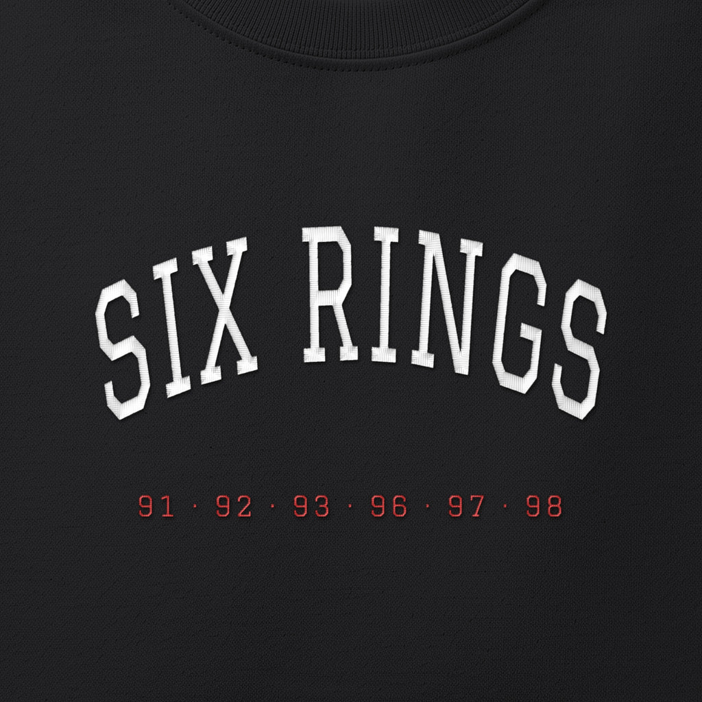 Close-up of the white & red satin-stitch Six Rings embroidery