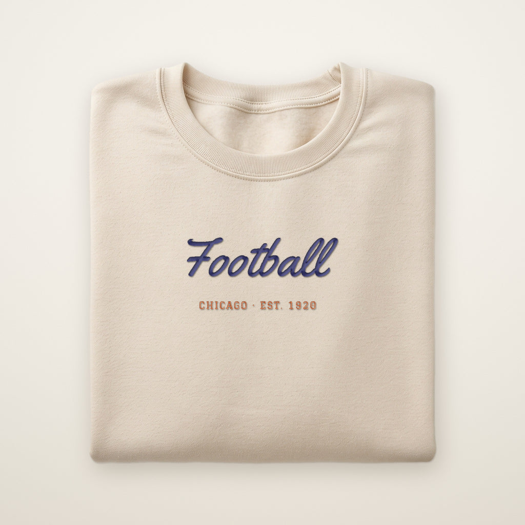Chicago Football Embroidered Crewneck — Football Script in Sand, flat lay