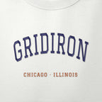 Close-up of the navy & orange satin-stitch Gridiron embroidery