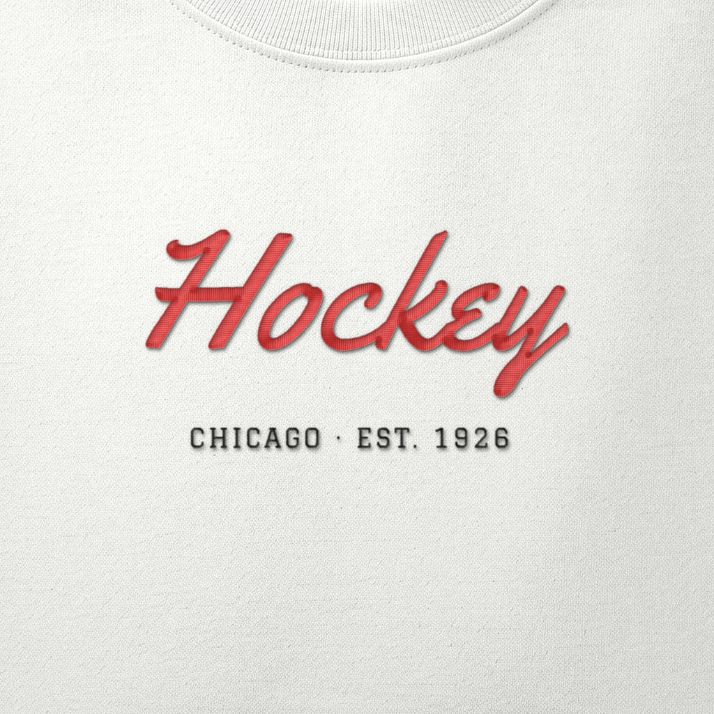 Close-up of the red & black satin-stitch Hockey Script embroidery