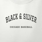 Close-up of the black satin-stitch Black & Silver embroidery