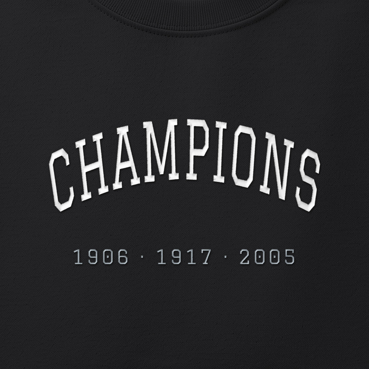 Close-up of the white & silver grey satin-stitch Champions embroidery